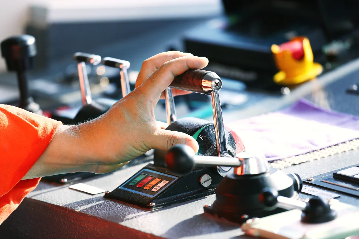 a marine personnel holding a control lever